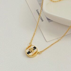 Tory Burch Elegant Gold and Black Pendant Necklace